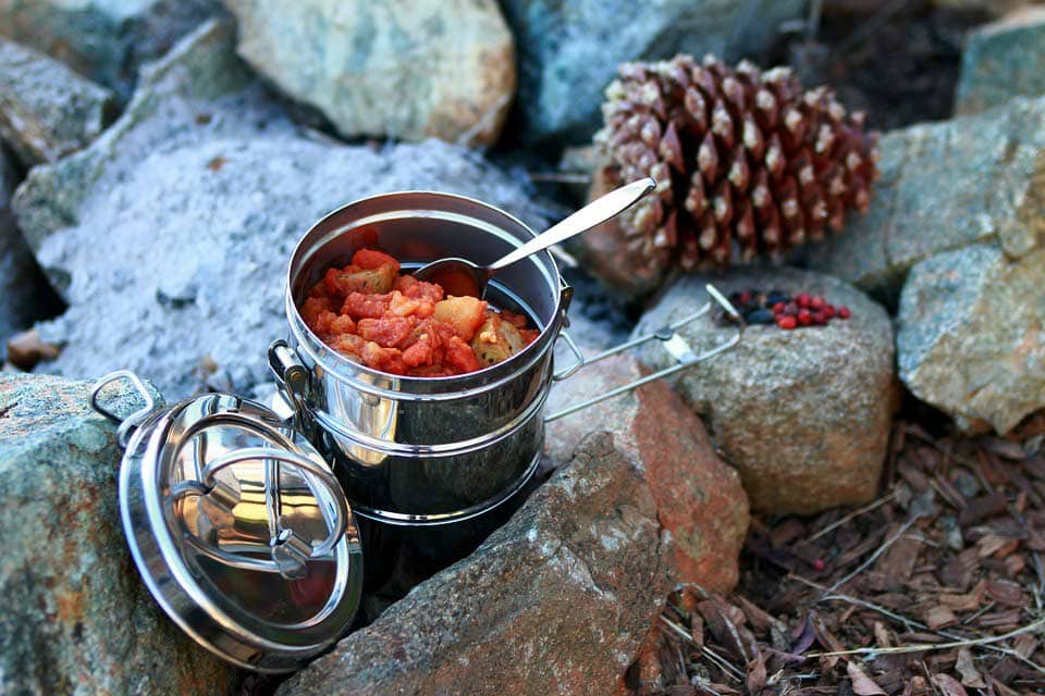 camping stove and a pot full of food